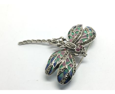 A silver plique-a-jour dragonfly brooch/pendant set with ruby eyes and marcasites.