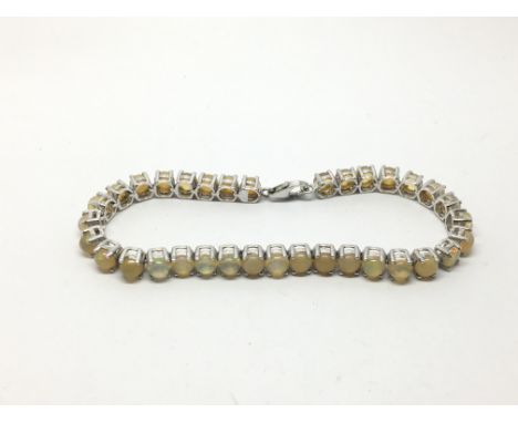 A silver opal line bracelet.