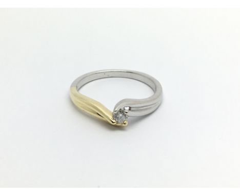 An 18carat white and yellow gold ring of modern design set with a solitaire diamond 0.12 of a carat ring size N-O