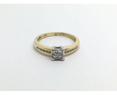 An 18carat gold ring set with princess cut diamonds with further diamonds set in the shank ring size L