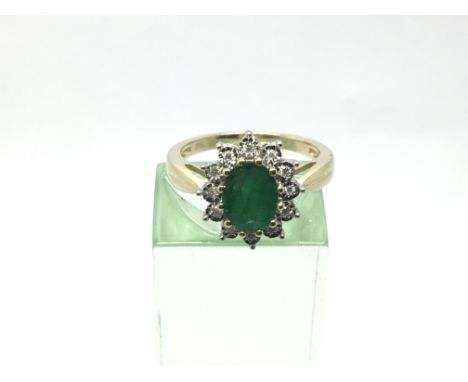 A 9ct gold oval cut emerald and diamond cluster ring, emerald approx 1.10ct, diamonds approx 0.06ct, approx 3.2g and approx s