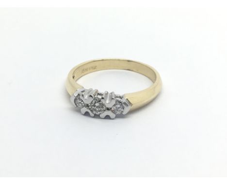 An 18carat gold ring set with three diamonds approximately 0.20 of a carat ring size M.