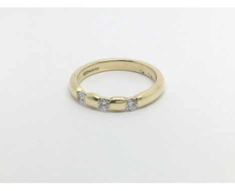 An 18carat yellow gold ring inset with three brilliant cut diamonds. Approximately 0.21 of a carat Ring size K