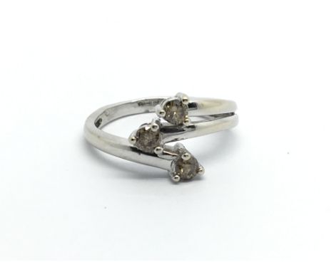 A modern design 9carat white gold ring set with champagne diamonds ring size K.