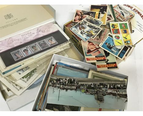 A collection of various presentation packs and first day covers, postcards and bubblegum and trade collectors cards