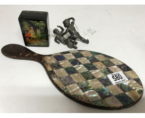 A tortoiseshell hand mirror inlaid with mother of pearl, together with a silver plated figure group of young boys fighting an