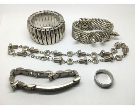 A titanium ring, three heavy bracelets and a necklace in the form of nuts and bolts.