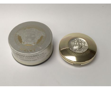 A boxed Versace compact