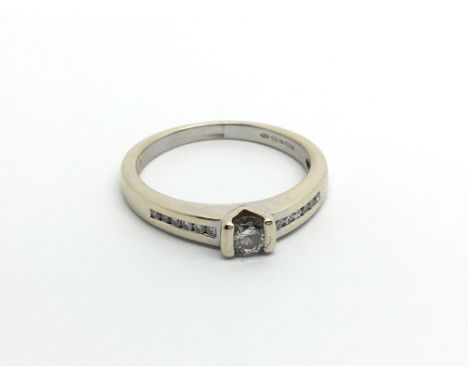 An 18carat gold ring set a diamond solitaire ring the shank set with further diamonds ring size O-P