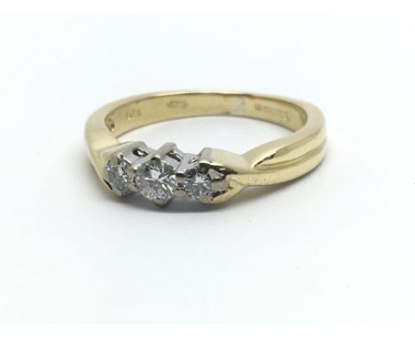 An 18ct yellow gold and three stone diamond ring, approx 0.20ct, ring size approx H