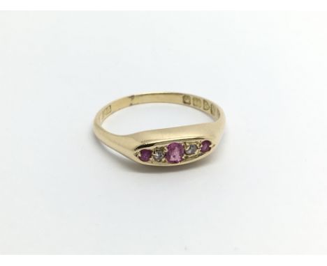 An 18carat gold ring set with three ruby and diamonds ring size N-O