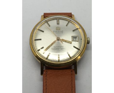 A Tissot Seastar Seven watch with baton numerals and champagne dial, seen working.
