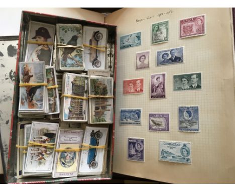 A stamp album containing mainly pre decimal Queen Elizabeth II GB, world and Commonwealth stamps plus a tin of cigarette card