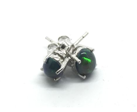 A pair of silver studs set with black Ethiopian opal.