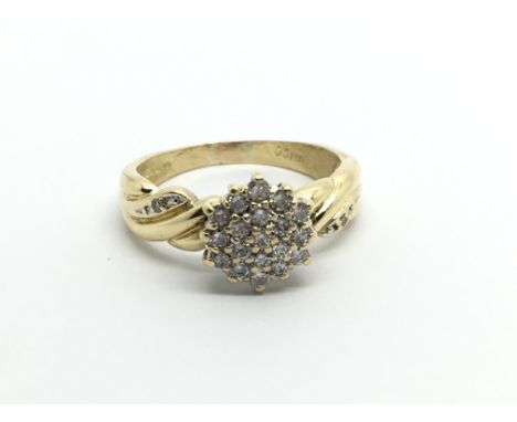 An 18carat gold ring set with a pattern of brilliant cut diamonds approximately 0.33 of a carat ring size N