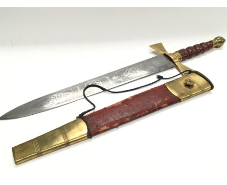 An Early 20th century Ceremonial short sword Masonic engraved blade Royal Arch with red leather and brass mounted scabbard.