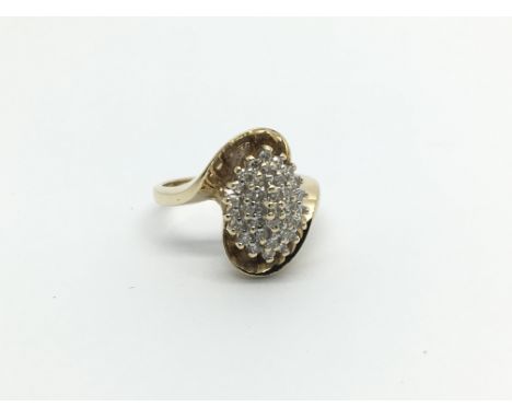 A 9carat gold ring set with a cluster pattern of diamond in an unusual shaped shank ring size M-N