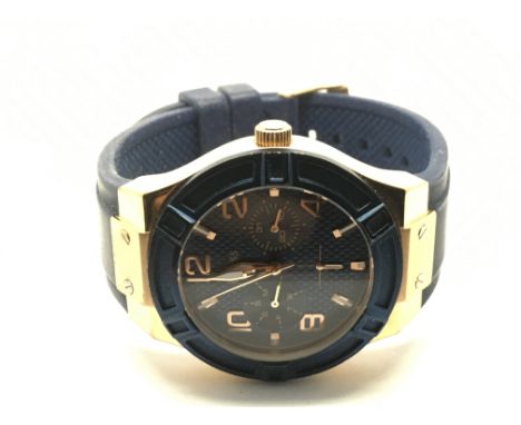 A Guess chronograph watch with blue strap.
