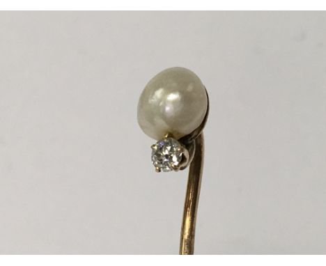 A gold, pearl and diamond stick pin.