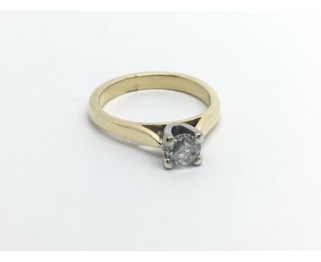 An unmarked gold ring possible 18carat gold ring set with a solitaire diamond approximately 0.33 of a carat ring size I-J