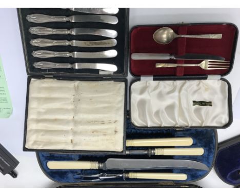 A cased carving set with silver collars together with a fish serving set , cased set of butter knives and a knife fork and sp