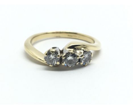 An 18ct yellow gold and three stone diamond ring, approx 0.30ct,