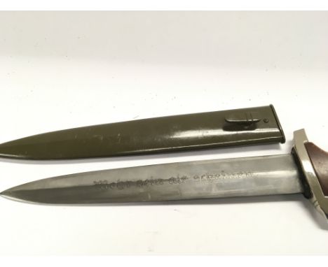 A German Third Reich dagger with a mahogany hardwood grip and green metal scabbard the pattern and design in keeping with NPE