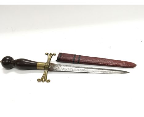 An early 20th century ceremonial dagger with a turned wood handle brass fittings steel blade and leather scabbard .