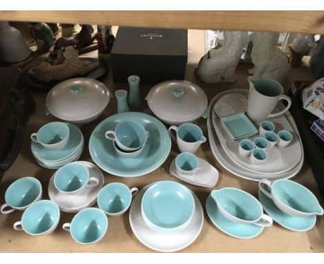 A Poole pottery dinner service including serving dishes, plates, dessert bowls, cups and saucers, cream jugs and gravy boats 