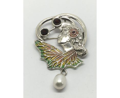 A silver plique-a-jour flora brooch/pendant set with garnets and ruby.