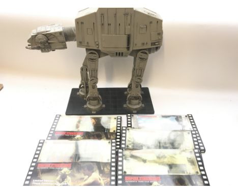 A Star Wars Limited edition At-At Walker model 2009 and a collection of Empire Strikes Back 70 mm film cells.