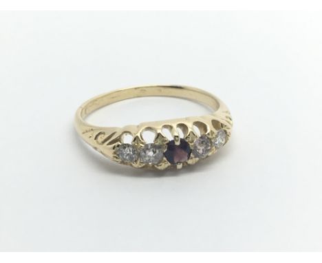 An 18carat gold ring set with a central ruby and flanked by diamonds ring size M.