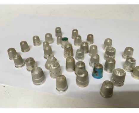 A good collection of silver thimbles including one decorated with enamel all with clear assay marks and in good condition.