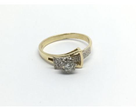 An 18carat gold ring set with diamonds and in the form of a simulated buckle ring size N.