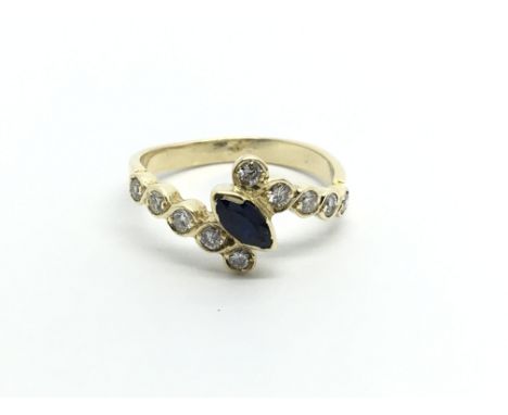 An unmarked gold ring set with a sapphire with a shaped shank set with diamonds ring size L