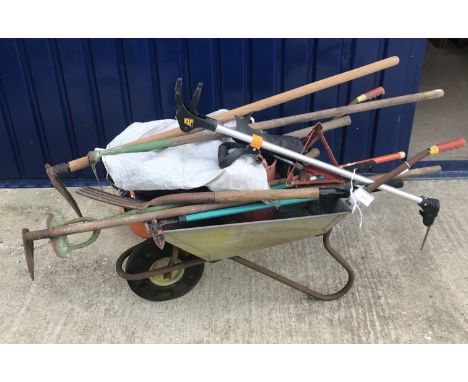 A large quantity of tools, spanners, shovels and a wheelbarrow