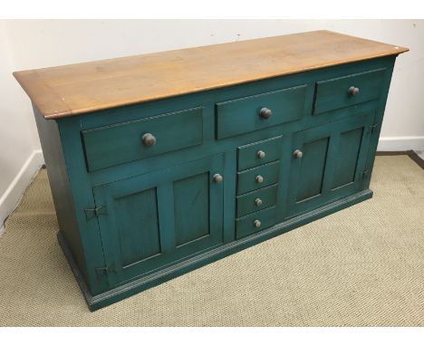 An oak and green painted dining room suite circa 1994, retailed by Heals, comprising a rectangular dining table on square sup