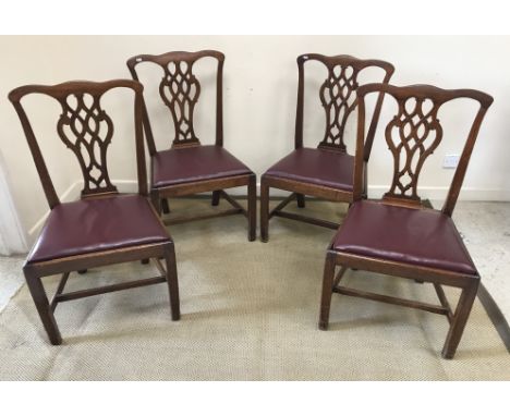 A set of four mahogany framed Provincial Chippendale style dining chairs with pierced back splats and drop in seats on square