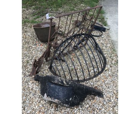 A collection of wrought ironwork to include a hayrack, a gate, a bootscrape, a water trough and a weathervane