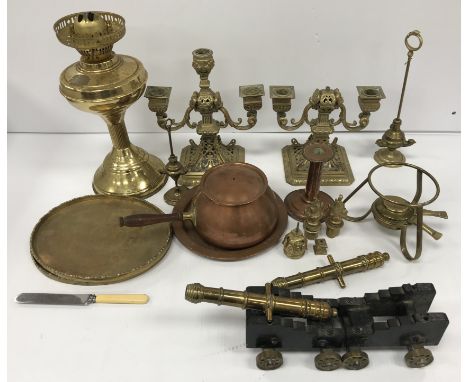 A 20th Century lacquered brass oil lamp, a pair of 20th Century cast brass canons on brass wheeled wooden carriages, a copper