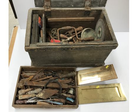A vintage pine trunk / tool chest and contents of various old hand tools and two brass letter box covers