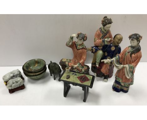 A collection of Chinese porcelain and other artefacts to include a Wucai pottery polychrome glazed figure group as a wife cle