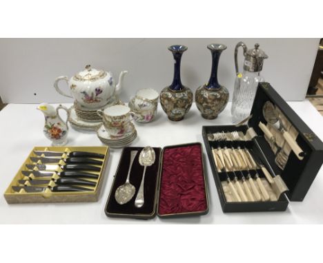 An early 20th Century Nymphenburg tea set of wrythen form with gilt decorated edging and floral spray decoration, bears blue 
