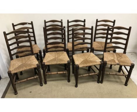 A set of eight oak rush seat ladder back dining chairs in the 17th Century style 46 cm wide x 94 cm high and three late Victo