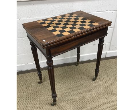 An early 19th Century mahogany Gonzales Alvez) games table, the chessboard satinwood and ebony inlaid top opening to reveal a