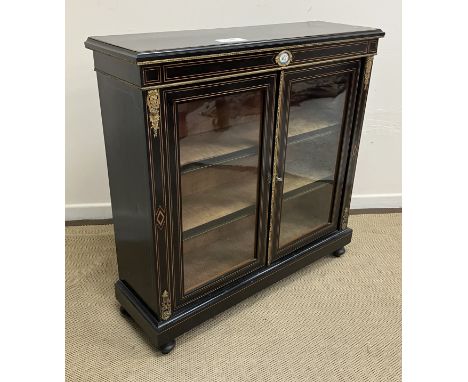 A late Victorian ebonised and inlaid side cabinet, the plain top with brass beaded edge over a satinwood strung frieze with c