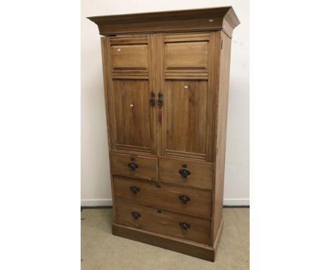 A circa 1900 walnut linen press by Shapland & Petter of Barnstaple, the moulded cornice over two twin panelled doors enclosin