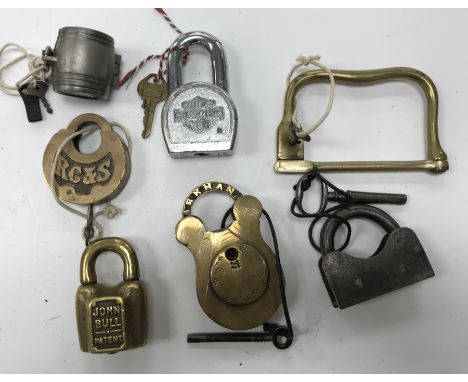 A collection of 7 various unusual padlocks including a John Bull Patent brass padlock by A.A.L. Co. W. Hall, a white metal bo