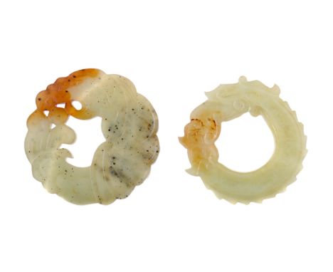 TWO CHINESE ARCHAIC STYLE HARDSTONE AMULETS, possibly jade, each of circular form, one carved with a dragon, the other with a
