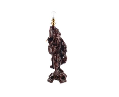 EARLY 20TH CENTURY CHINESE CARVED HARDWOOD FIGURAL LAMP, modelled as a fisherman, 43cm high